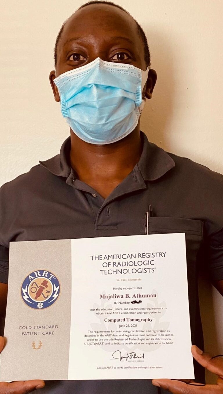 Majaliwa Athuman holding his ARRT CT Certificate cropped